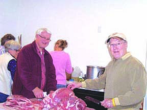 Ed Hollenback and Roger Brown take a second to smile for the camera as they 'keep guard' over the meat.