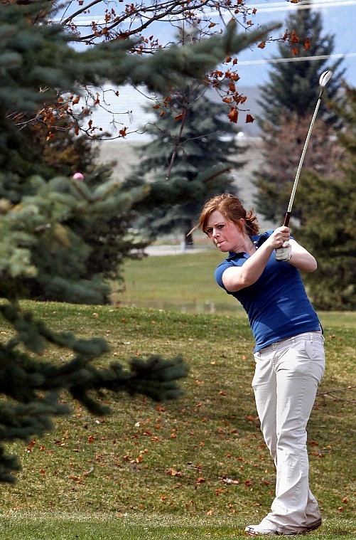 Cut Bank's Mariah McCormick hits her ball around a tree toward the green.