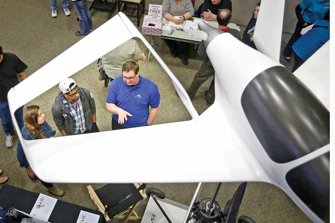 &lt;p&gt;Preston Van Vleet of Synergy Aircraft speaks with job seekers during the Flathead Valley Job Fair at Flathead Valley Community College. Synergy brought a to-scale model of an aircraft to attract job seekers to its booth. (Brianna Loper/The Daily Inter Lake)&lt;/p&gt;