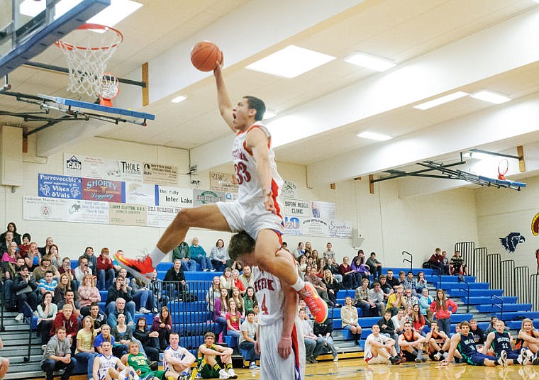 &lt;p&gt;Bigfork's Christian Evans (33) soars over teammate Austin Jordt to win the dunk competition Wednesday afternoon during the Les Schwab Shootout at Bigfork High School. April 10, 2013 in Bigfork, Montana. (Patrick Cote/Daily Inter Lake)&lt;/p&gt;