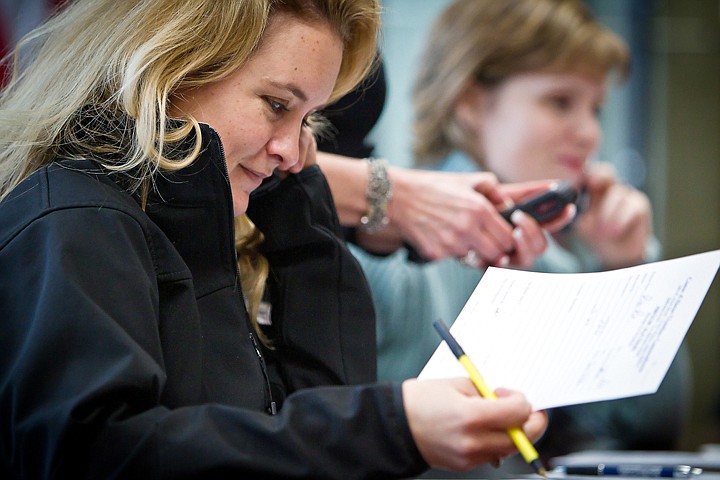 &lt;p&gt;Jennifer Riley makes a phone call Tuesday as she seeks out donations for the Coeur d'Alene Area Chamber of Commerce's Aw$um Auction May 1.&lt;/p&gt;