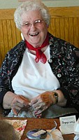 <p>Marjorie Olsen, one of the founding members of the hobby club, enjoys a laugh at the April meeting, when the women made sachets from vintage handkerchiefs.</p>