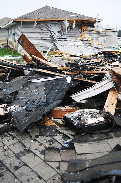 <p>The wreckage of a rental home fills the lot at the corner of 7th and C Streets on Monday afternoon, April 16, in Dayton. The house exploded Friday evening. First responder Jason Heffner of the Chief Cliff Fire Department estimates he was on the scene and calling dispatch at around 11:30 as debris from the blast was still falling from the sky. Heffner said the investigators have not made an official ruling on the cause of the blast yet, but a propane furnace is suspected. The blast completely destroyed on house and did structural damage to the house next door. Heffner said the blast was heard across the lake as far as Big Arm.</p>