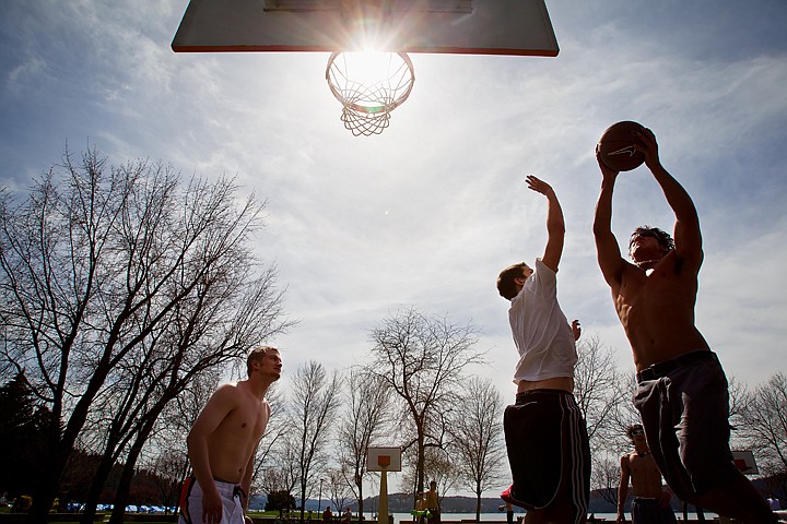 &lt;p&gt;SHAWN GUST/Press Claude Young, a North Idaho College wrestler, 20, right, takes an outside shot against Kevin Klundt Friday as Sam Braseth, far left, positions himself for a rebound while playing basketball at the Coeur d'Alene City Park. Temperatures in the 70's brought droves of residents out to recreate in local parks.&lt;/p&gt;