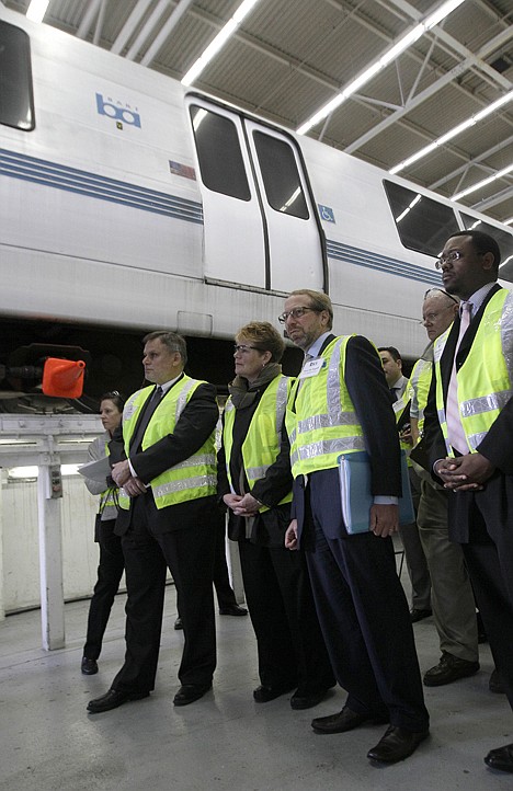 &lt;p&gt;In this photo taken Wednesday, Federal Transit Administrator Peter Rogoff, second from right, and Bay Area Rapid Transit (BART) General Manager Grace Crunican, second from left, and others, stand near a BART train during a tour of the BART Maintenance Yard in Hayward, Calif.&lt;/p&gt;