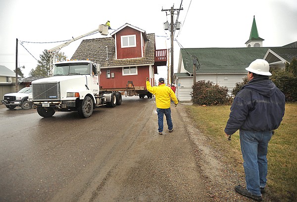 Kinniburgh Construction moves the Blacktail Mountain Ski Area office building on Tuesday morning in Lakeside.
Steve Kinniburgh watches and gives directions to the driver. The building was moved from the west side of U.S. 93 to a new spot near Lakeside Mercantile. The Blacktail office and many other buildings have been moved off property that Bruce Ennis and his wife, Margaret Davis, will develop into a new county park on Flathead Lake.