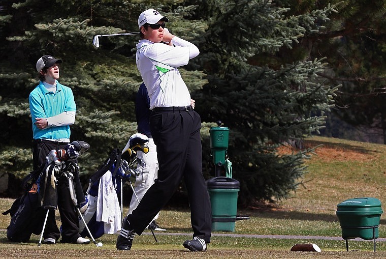 Bigfork&#146;s Kyle Parker tees off while Missoula Loyola&#146;s Carter Bermingham looks on during the Bigfork Invitational Thursday morning at Eagle Bend Golf Course in Bigfork. Parker tied for second place with Missoula Loyola&#146;s Alex Carlson.