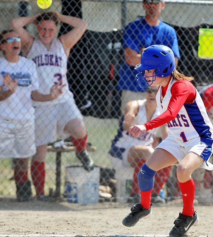 Columbia Falls' Tori Price stops in her tracks between third and home base as the ball sails over her head during the first game of a doubleheader against Havre Saturday afternoon. Price was caught in a pickle but made it safely back to third base.