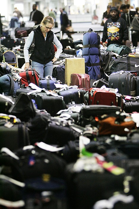 &lt;p&gt;Carolann Manfredi, of Princeton, N.J., searches through luggage for a bag she says has been missing for five days, at the Philadelphia International Airport on Feb. 20.&lt;/p&gt;