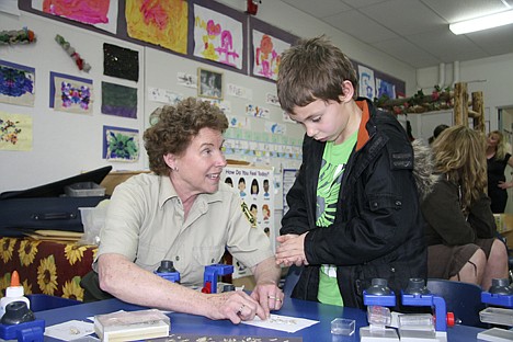 &lt;p&gt;Bridger Stevens, 6, of Coeur d'Alene, gets help from volunteer Beth Paragamian of Coeur d'Alene, identifying the bones of a mouse using a skeleton chart during the Earth Day Coeur d'Alene Saturday. The bones, from the entire skeleton, were pulled from a ball coughed up by an owl.&lt;/p&gt;