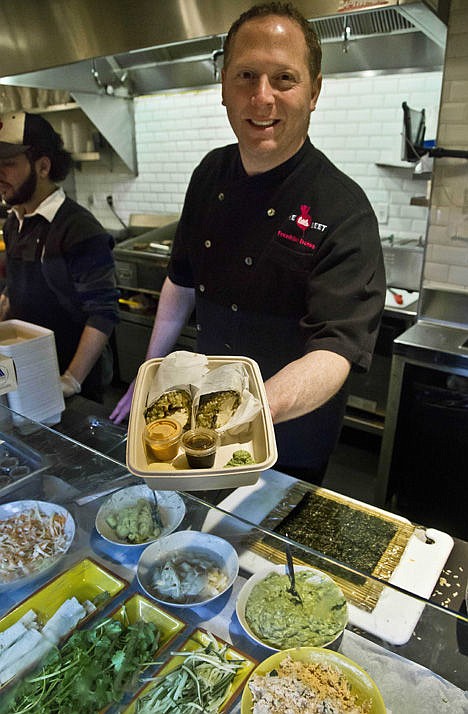 &lt;p&gt;Chef Franklin Becker, center, holds a freshly prepared dish at The Little Beet during lunchtime at the restaurant in New York., March 12.&lt;/p&gt;