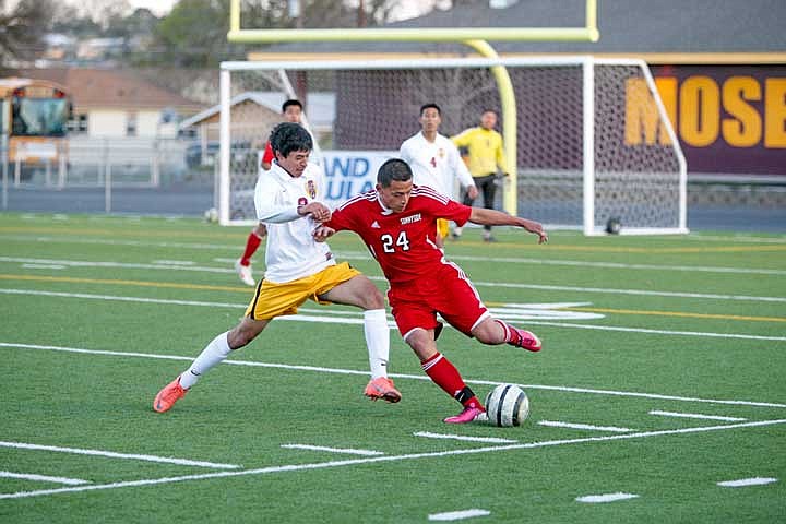 Alexis Meza battles a Grizzlie defender for control of the ball.