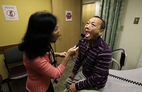 &lt;p&gt;Chan Lai Ly, right, has his mouth examined by Honghue Duong, a physician's assistant, as part of a regular check-up related to his diabetes at International Community Health Services in Seattle, March 1, 2013.&lt;/p&gt;