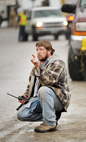 Steve Kinniburgh watches and gives directions to the driver moving the Blacktail Mountain Ski Area office building to a new location in Lakeside on Tuesday.