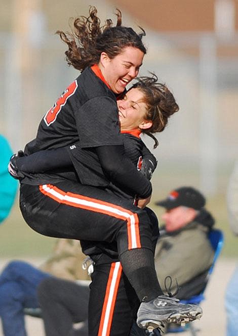 Flathead senior Alanna Handford (photo right) jumps in the arms of freshman slugger Anna Costa to celebrate their victory over Glacier at Conrad Complex on Friday. Flathead won 5-4. Glacier won the second game 14-0. Garrett Cheen/Daily Inter Lake