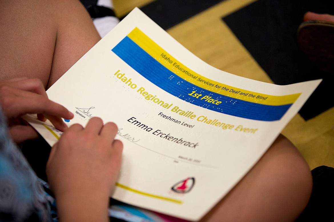 &lt;p&gt;Emma Erckenbrack runs her hands over her first place Idaho Regional Braille Challenge award certificate on Tuesday to read the braille on it.&lt;/p&gt;