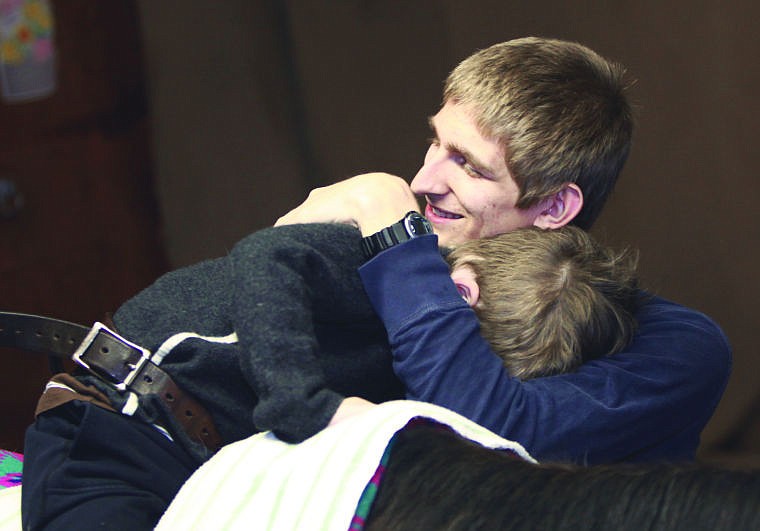 <p><span><strong>Six-year-old</strong> Charlie Jones gives Skyler Bexten, 18, a hug during a SAMS Riders session with Human Therapy on Horseback. Charlie and Skyler share an unspoken deep understanding and a bond: Both have been diagnosed with autism spectrum disorder. </span></p>
<div><span><br /></span></div>