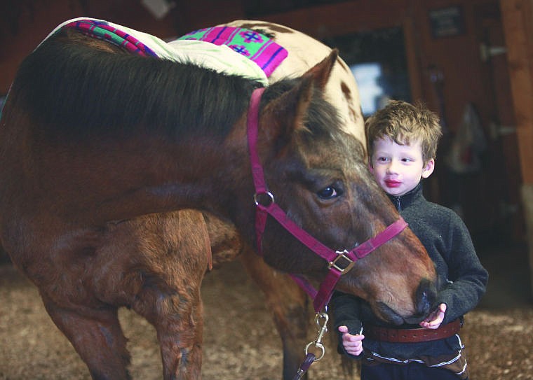 <p>Charlie loves to feel the horse’s breath on his hands. Working with the animals — and Skyler — helps Charlie build self-confidence and feel proud of all he has accomplished.</p>