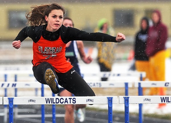 Flathead’s Liz Chmielewski clears a hurdle during the 100-meter event on Tuesday in Columbia Falls.