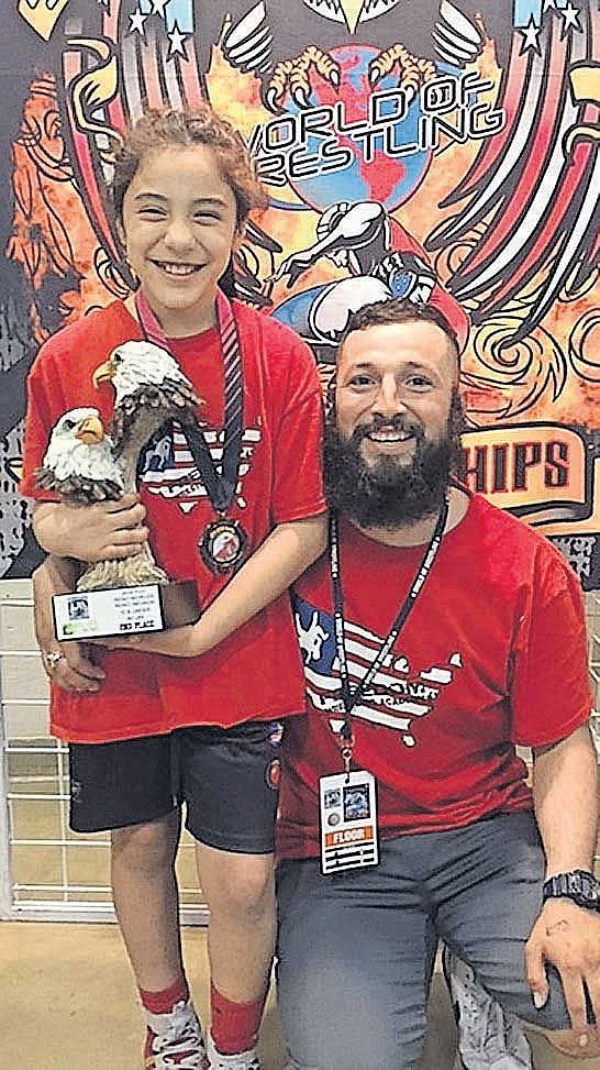 Emma and her father Carlos are all smiles after she makes All-American for the second straight year at the Worlds wrestling tournament.