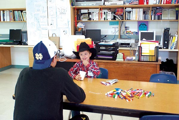 Austin Baldwin shares a laugh with student volunteer Arlee senior Jesse Pfau during snack time of the Arlee Friday Free Three program.