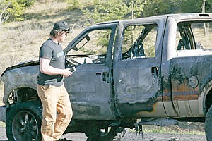 &lt;p&gt;Ben Swanson looks over the remains of his 2008 Ford Super Duty after Saturday's fire. (Parked in the turnout across the road from the Strawberry Patch, aprox. mile marker 26.)&lt;/p&gt;