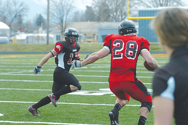 Bo Herak, of Charlo, looks to stop Charloe Dotson, of Kalispell.