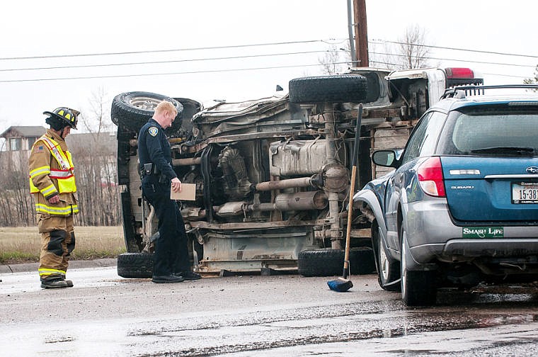 &lt;p&gt;Kalispell Police Department's Jason Parce and Kalispell Fire Department firefighter Doug Schwartz, left, inspect the scene of two-vehicle crash that left a truck on its side Thursday afternoon on U.S. 93 in front of Flathead Valley Community College. April 17, 2014 in Kalispell, Montana. (Patrick Cote/Daily Inter Lake)&lt;/p&gt;