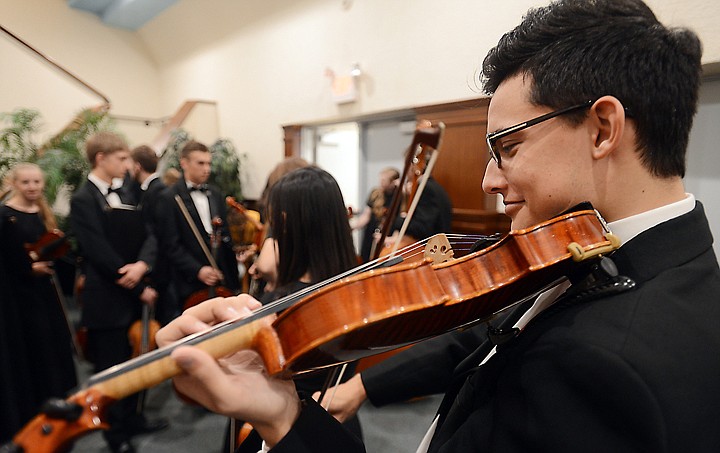 &lt;p&gt;Violin player Christian Diaz, a senior, warms up before the Glacier High School Chamber Orchestra takes the stage at the District Music Festival on Friday at Flathead High School.&lt;/p&gt;