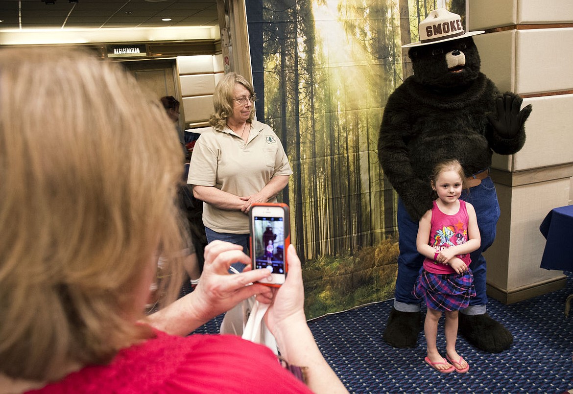 &lt;p&gt;Mica McKee, 5, stands next to Smokey Bear for a picture during the Smokey Bear Association convention held at the Coeur d'Alene Resort on Tuesday.&lt;/p&gt;