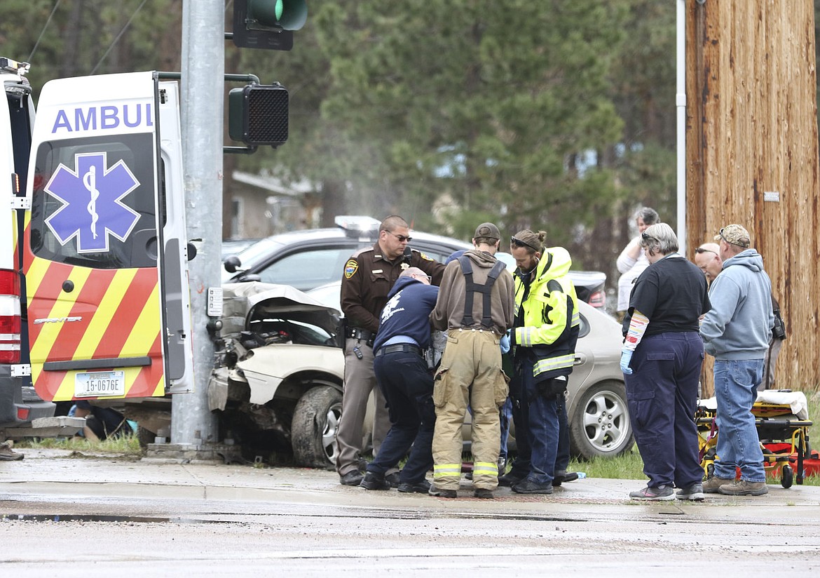 &lt;p&gt;First responders work on an occupant of the vehicle that crashed into a stoplight pole in Pablo Wednesday afternoon.&lt;/p&gt;