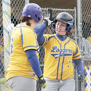 <p>Dayln Germany exchanges high-fives with Auria Benefield prior to batting vs. Eureka with Benefield on deck. April 11, 2015</p>