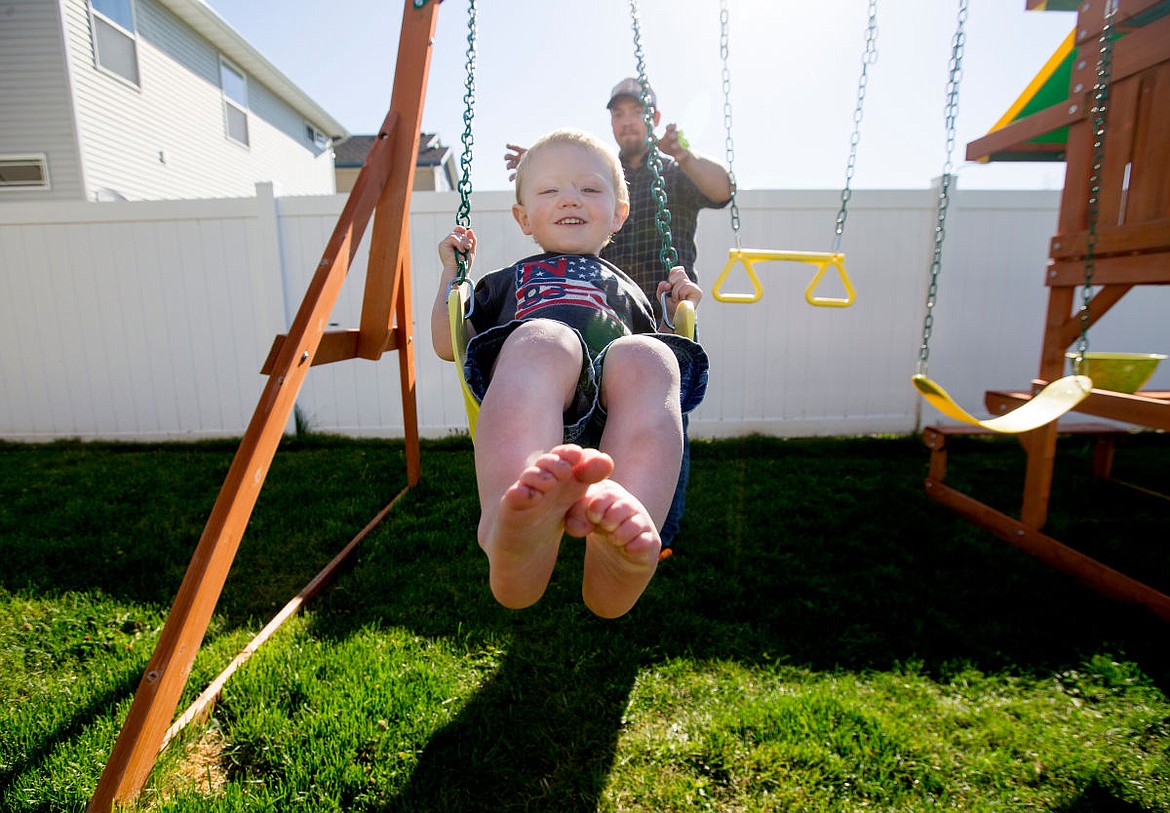 &lt;p&gt;Archer Underdahl smiles as he is pushed on his family's swingset by his father Scott on Tuesday in the backyard of the Underdahl's Post Falls home.&lt;/p&gt;