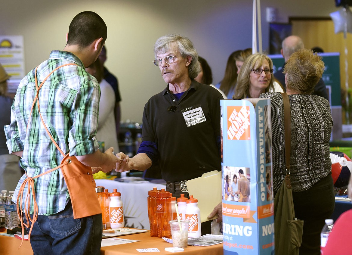 &lt;p&gt;U.S. Army veteran Ivan Murdoch takes a card from Home Depot's Oscar Coronado during the Flathead Valley Job Fair at the Flathead Valley Community College on Thursday. (Aaric Bryan/Daily Inter Lake)&lt;/p&gt;