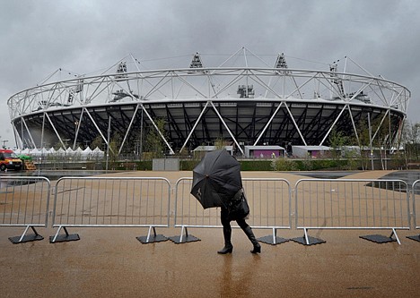 &lt;p&gt;A woman struggles with an umbrella as the heavy rain falls outside the Olympic Stadium, in London Wednesday April 18, 2012. Wednesday marks 100 days before the London 2012 Olympic Games begin. (AP Photo/Anthony Devlin/PA) UNITED KINGDOM OUT&lt;/p&gt;