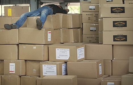 &lt;p&gt;A laborer takes a nap over boxes of cargo piled up for Europe at the air cargo terminal in Dhaka, Bangladesh, Wednesday, April 21, 2010. The International Air Transport Association says disruptions to European air travel from the volcanic ash cloud have cost the industry at least $1.7 billion. (AP Photo/Pavel Rahman)&lt;/p&gt;