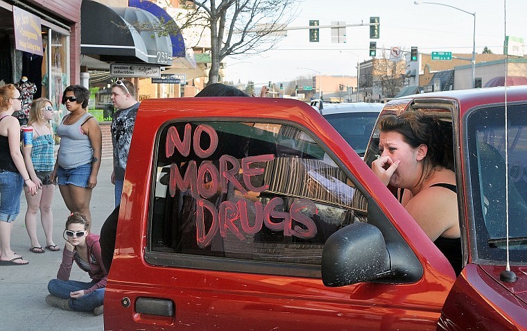 Meghan Mansell, ex-girlfriend of Jeffrey Nixon, loses control of her emotions while sitting in a truck outside Club Dungeon Tuesday before joining others en route to Wesley Collins&#146; home. Nixon is being held in connection with Collins&#146; murder.