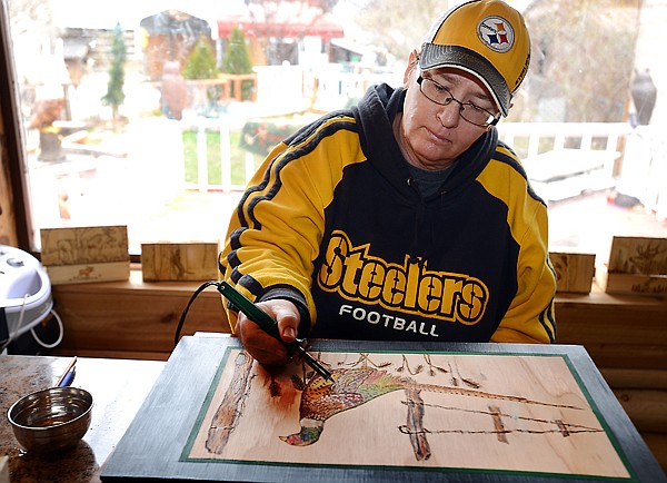 &lt;p&gt;Dale Cordier-Homan works on a new wood burning of a pheasant on Monday, April 15, at her home in Kalispell. (Brenda Ahearn/Daily Inter Lake)&lt;/p&gt;