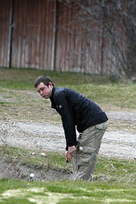 Jake Bauer chips from the sand trap onto the green last Saturday in Plains.