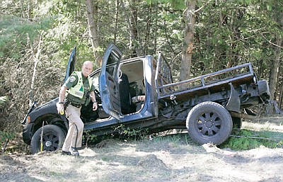 &lt;p&gt;MHP Trooper Bryce Ford at the scene of a single vehicle accident involving a blue and black 2002 4-door Dodge pickup at Highway 2 and Yaak Hill April 18, 2016.&lt;/p&gt;