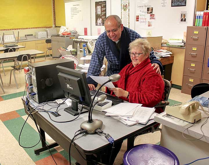 Kathleen Schutz and one of her dearest friends, Mario Godoy-Gonzalez, share a moment and some information in her classroom.