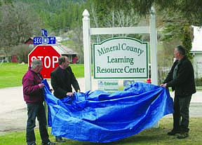 Commissioners Clark Conrow, Roman Zylawy and Duane Simons were impressed with the sign as it was revealed. The audience was also wowed by how wonderful it looked.