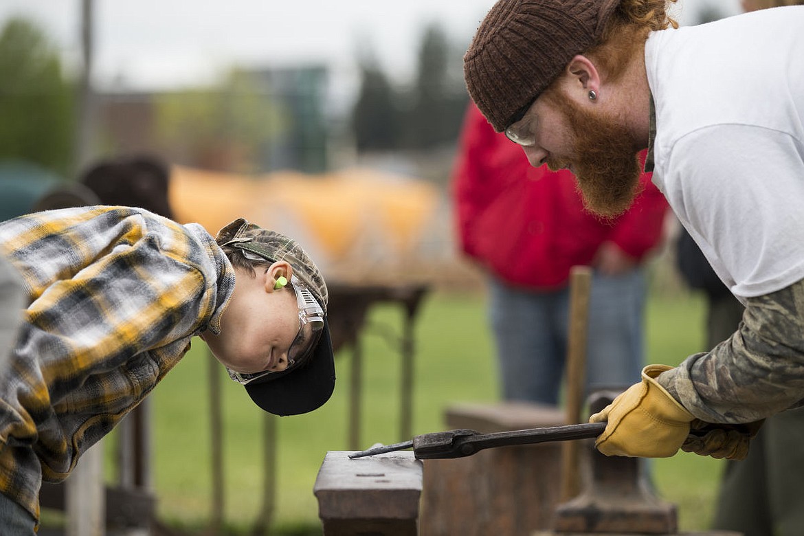 &lt;p&gt;Kenny Anthony, right, shows Jayvin Ciero, left, his work on a metal punch for a Boy Scout Merit Badge on Saturday at the Kootenai County Fairgrounds.&lt;/p&gt;