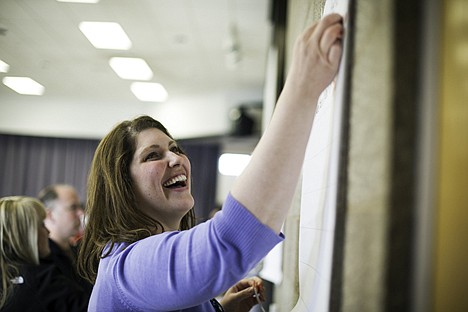 &lt;p&gt;Janelle Baker, principal at Prairie View Elementary School, places a red sticker next to a topic she feels should be a district priority Tuesday during a Post Falls School District budget workshop.&lt;/p&gt;