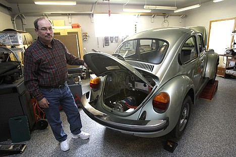 &lt;p&gt;Dean West poses next to the engine compartment of the 1974 Volkswagen Super Beetle he has converted to run on all-electrical power in the garage of his home on April 20 in Milton, Wash.&lt;/p&gt;