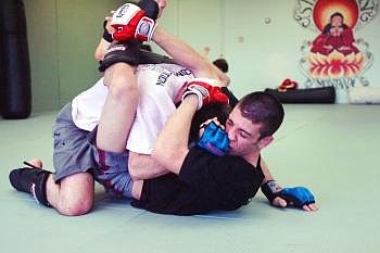 Hamilton Ash (right) catches a shot to the nose from Ryan Asay's fist during practice at Kalispell's Straight Blast Gym, located at 419 First Avenue East. The gym is open throughout the week offering classes in Brazilian Jiu Jitsu with Gi, submission wrestling, and mixed martial arts. Four fighters from SBG are competing in Saturday's amateur event at Majestic Valley Arena. Nate Chute photo/Daily Inter Lake