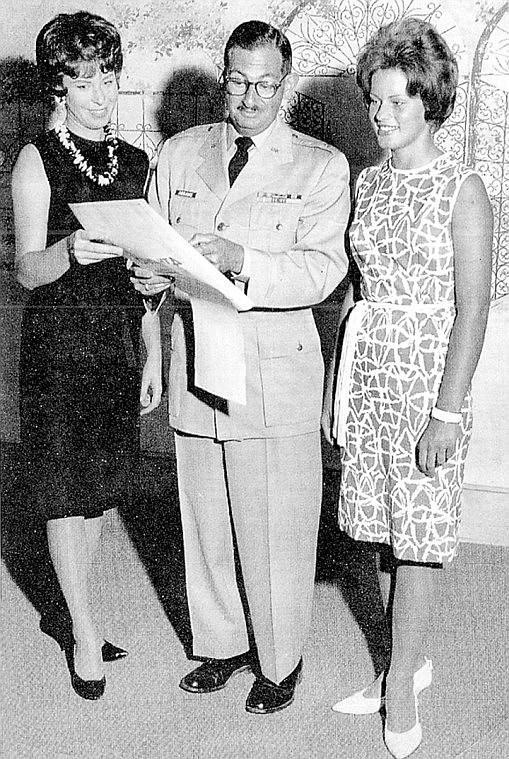Miss Moses Lake Louise Fuller, left, confers with Major Carl Abrams, of Larson Air Force Base, and Miss Larson Air Force Base Carolyn Walsh about preparations for the 1963 Friendship Day on July 4 at the Moses Lake State Park.