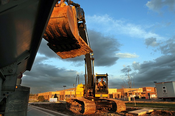 The crew from LHC, Inc. tears out the sidewalk along Hutton Ranch Road on Thursday evening in Kalispell. The road is being widened and by June there will be two lanes going into the new Walmart.