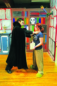 Dracula (Josh Wright) goes to choke one of the castle's visitors, Lily, portrayed by Liz LaPierre.