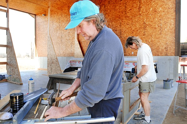 Bruce Smith of Bigfork, left, and Greg Nelson of Kalispell, work on building doors for a barn on Monday east of Kalispell.